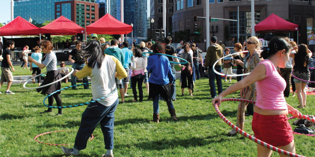 People playing hula hoop in a field