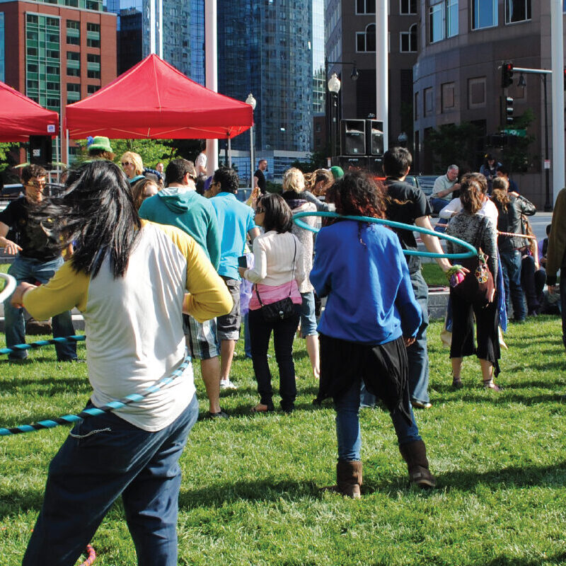 People playing hula hoop in a field